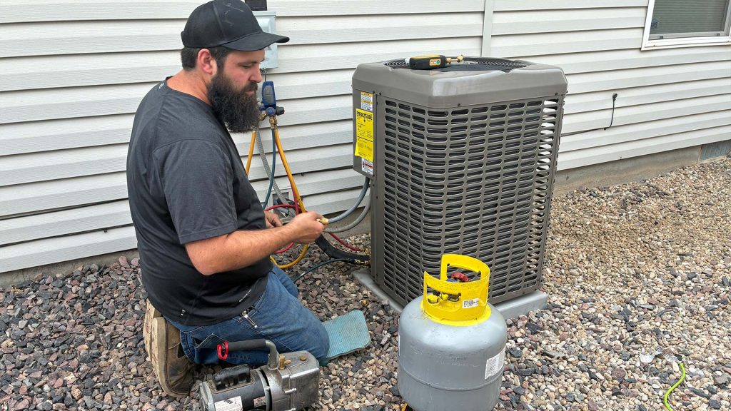 Technician installing A/C unit