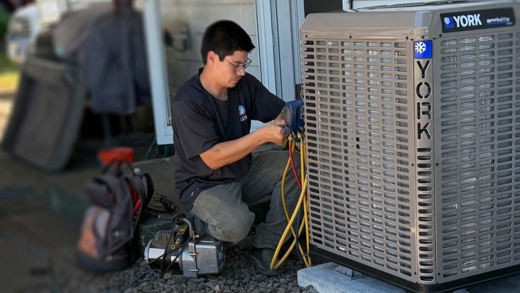 Technician installing a heat pump