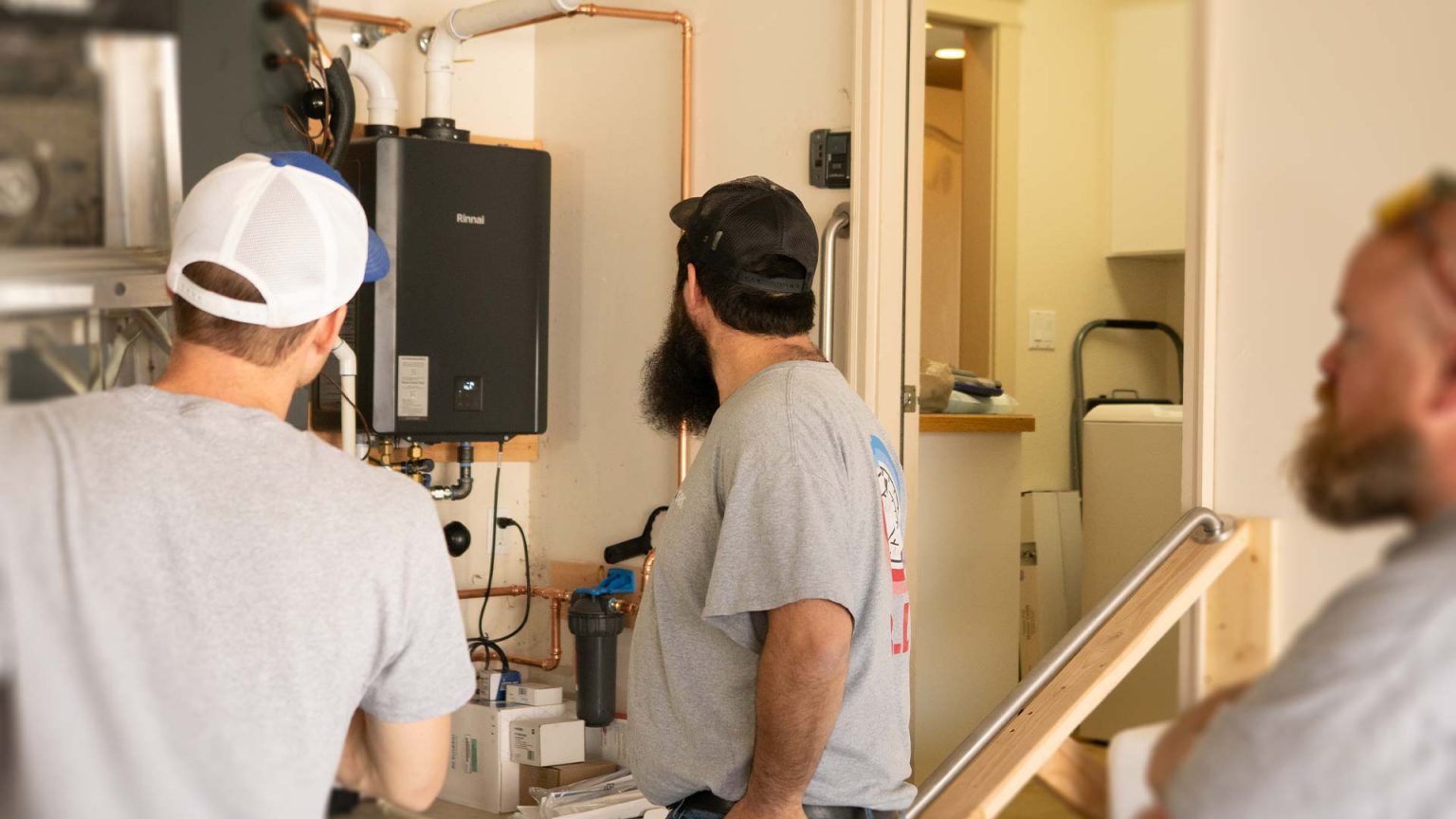 Technicians with installed tankless water heater