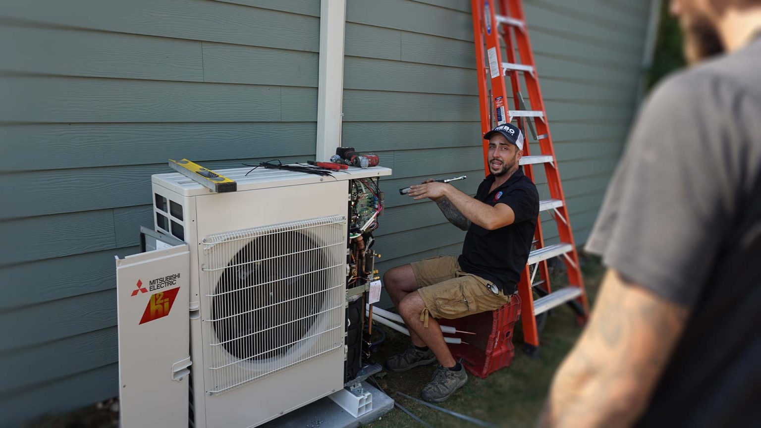 Technicians installing a ductless system