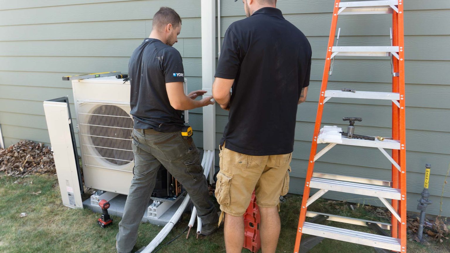 Technicians installing a ductless system