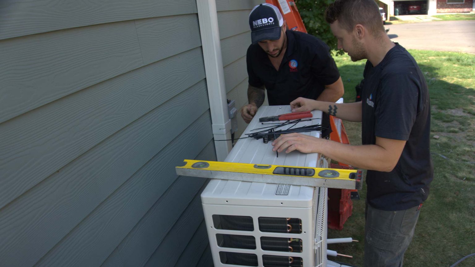 Technicians installing a ductless system