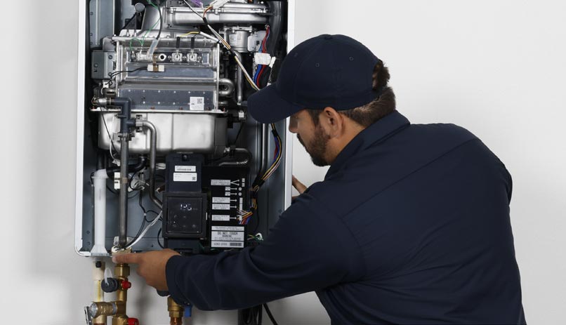 Technician working on tankless water heater